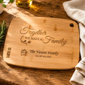 Personalised bamboo chopping board engraved with family name and special date on a rustic oak kitchen countertop with rosemary and linen cloth.